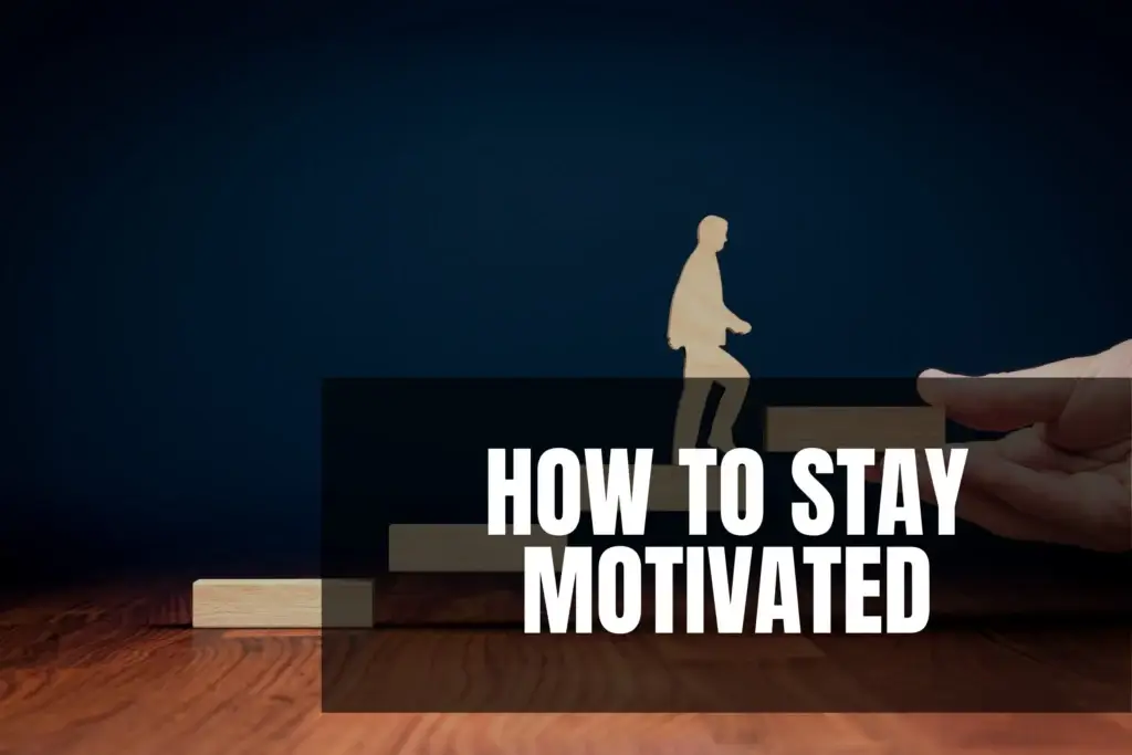 A person is shown climbing wooden blocks that look like stairs, while a hand adds the last block. The words HOW TO STAY MOTIVATED appear in big, bold letters on a dark background.
